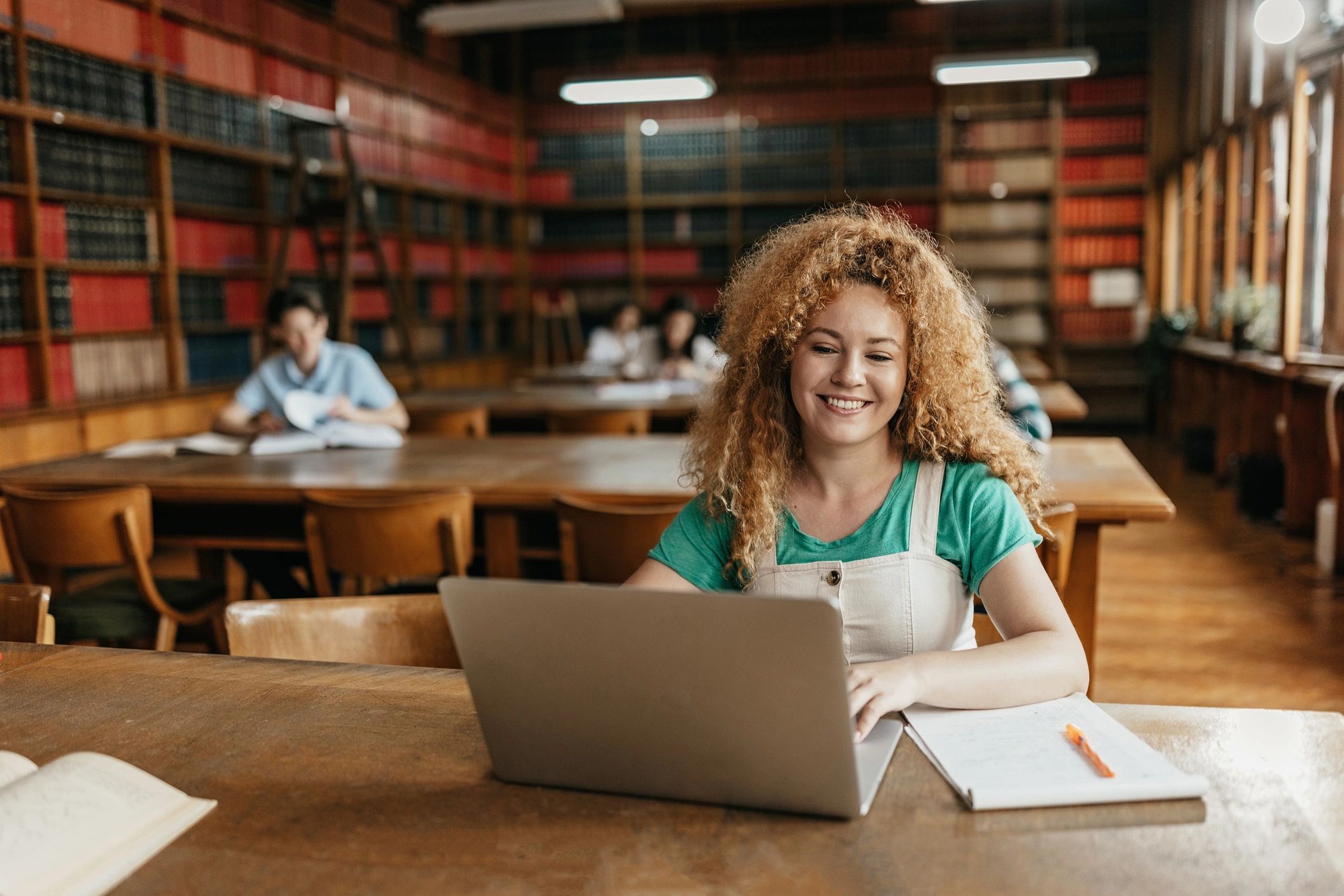 Young woman working on a laptop for writing and editing